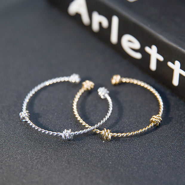 Three knotted opening bracelets